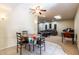 Charming dining area featuring tile floors, table with a colorful cover, and a view into the living room at 13404 W Copperstone Dr, Sun City West, AZ 85375