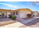 Charming home featuring a well-maintained walkway, complemented by verdant landscaping and lovely desert rock at 13404 W Copperstone Dr, Sun City West, AZ 85375