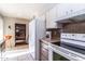 Cozy kitchen features white appliances, tile backsplash, and light countertops at 13404 W Copperstone Dr, Sun City West, AZ 85375