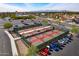 Aerial shot of multiple pickle ball courts with lush greenery and parked cars in the parking at 13404 W Copperstone Dr, Sun City West, AZ 85375