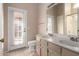 Bright bathroom features a double sink vanity, neutral walls, and a door to the exterior at 15431 S 36Th Pl, Phoenix, AZ 85044