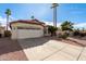 Charming single-story home featuring a two-car garage, desert landscaping, and mature palm trees at 15431 S 36Th Pl, Phoenix, AZ 85044