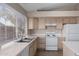 Kitchen featuring white appliances, wood cabinetry, and natural light at 15431 S 36Th Pl, Phoenix, AZ 85044