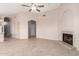 Bright living room featuring a ceiling fan, a fireplace, and tiled floors at 15431 S 36Th Pl, Phoenix, AZ 85044