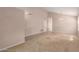 Spacious living room with neutral carpet, tile entryway, and a view to another room through an archway at 15431 S 36Th Pl, Phoenix, AZ 85044