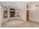 Sunlit living room showcases decorative windows, neutral carpet, and inviting front entrance at 15431 S 36Th Pl, Phoenix, AZ 85044