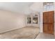 Sunlit living room showcases decorative windows, neutral carpet, and inviting front entrance at 15431 S 36Th Pl, Phoenix, AZ 85044