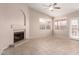 A spacious living room featuring tile flooring and a cozy fireplace at 15431 S 36Th Pl, Phoenix, AZ 85044