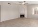 Bright living room with tile flooring, fireplace, and a window providing natural light at 15431 S 36Th Pl, Phoenix, AZ 85044