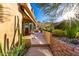 Desert home patio with red chairs and desert landscaping and retaining wall at 15501 E Tepee Dr, Fountain Hills, AZ 85268