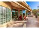 Desert home patio with glass brick and desert landscaping; red chairs and patio table at 15501 E Tepee Dr, Fountain Hills, AZ 85268