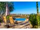 Desert home pool with lounge chairs and shade umbrella, desert views, and native vegetation at 15501 E Tepee Dr, Fountain Hills, AZ 85268