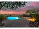 Poolside view with desert landscape, outdoor chairs, and sunset sky at 15501 E Tepee Dr, Fountain Hills, AZ 85268