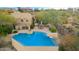 Inviting pool area featuring a sparkling blue pool, lush landscaping, and a cozy patio with lounge chairs at 15501 E Tepee Dr, Fountain Hills, AZ 85268