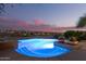 Beautiful pool with built-in lights offers a relaxing experience at dusk at 15501 E Tepee Dr, Fountain Hills, AZ 85268