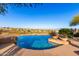 A desert home pool with a negative edge and desert views; desert landscaping and potted plants around the pool area at 15501 E Tepee Dr, Fountain Hills, AZ 85268