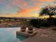 Infinity pool and mountain view at sunset creates a serene outdoor experience at 15501 E Tepee Dr, Fountain Hills, AZ 85268