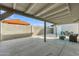 Covered back patio with concrete floor offers a place to relax and enjoy the fresh air at 16239 N 47Th Dr, Glendale, AZ 85306