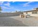 Large backyard featuring gravel landscaping, outdoor fire pit seating, and a block wall fence at 16239 N 47Th Dr, Glendale, AZ 85306