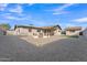 Spacious backyard with gravel landscaping, artificial turf, fire pit with seating and detached shed at 16239 N 47Th Dr, Glendale, AZ 85306