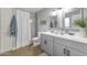 Bathroom featuring a double sink vanity with white quartz countertops and grey cabinets at 16239 N 47Th Dr, Glendale, AZ 85306