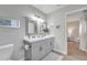 Bright bathroom featuring a dual sink vanity with framed mirrors and modern fixtures at 16239 N 47Th Dr, Glendale, AZ 85306