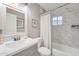 Bathroom featuring a shower, bathtub, single sink vanity, and decorative mirror at 16239 N 47Th Dr, Glendale, AZ 85306