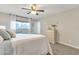 Comfortable bedroom with a ceiling fan, a dresser, and soft window lighting at 16239 N 47Th Dr, Glendale, AZ 85306