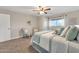 Bedroom with a ceiling fan, natural light, and coordinated decor; includes seating at 16239 N 47Th Dr, Glendale, AZ 85306