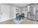 Dining area with a black table set, a stainless steel fridge, and wood-look flooring at 16239 N 47Th Dr, Glendale, AZ 85306