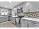 Modern kitchen featuring stainless steel appliances, sleek countertops, and stylish finishes at 16239 N 47Th Dr, Glendale, AZ 85306