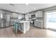 Modern kitchen featuring stainless steel appliances, sleek gray cabinetry, a center island, and stylish finishes at 16239 N 47Th Dr, Glendale, AZ 85306