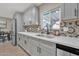 Charming kitchen featuring a stainless steel sink, quartz counters and colorful backsplash tiles at 16239 N 47Th Dr, Glendale, AZ 85306