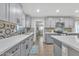 Updated kitchen with grey cabinetry, quartz countertops, stainless appliances and decorative tile backsplash at 16239 N 47Th Dr, Glendale, AZ 85306