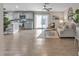 Open-concept living room with wood floors, and a neutral color scheme creating a warm and inviting atmosphere at 16239 N 47Th Dr, Glendale, AZ 85306