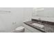 Modern bathroom featuring granite countertops, a sink, a large mirror, and a toilet at 1689 N Fenway Dr, Florence, AZ 85132