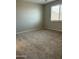 Spacious bedroom with neutral carpeting and a large window for natural light at 17916 W Puget Ave, Waddell, AZ 85355