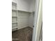 Walk-in closet with built-in shelving and hanging rods, offering ample storage space at 17916 W Puget Ave, Waddell, AZ 85355