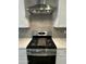 Close-up of the stainless steel stove with range hood and subway tile backsplash in the kitchen at 17916 W Puget Ave, Waddell, AZ 85355