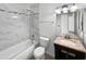 Bathroom featuring updated tiling, bathtub and shower combo, new lighting, and stylish vanity at 1805 E Bluefield Ave, Phoenix, AZ 85022