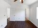 Bright empty bedroom featuring wood floors, a large window and two doorways at 1805 E Bluefield Ave, Phoenix, AZ 85022