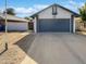 Exterior shot of home featuring a large garage and well maintained lawn at 1805 E Bluefield Ave, Phoenix, AZ 85022