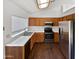 Well-lit kitchen featuring stainless steel appliances, wooden cabinets and tile countertops at 1805 E Bluefield Ave, Phoenix, AZ 85022