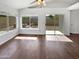 Living room featuring hardwood floors, large windows and sliding glass door access to the backyard at 1805 E Bluefield Ave, Phoenix, AZ 85022