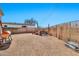 Spacious backyard with a seating area, a grill and easy to maintain desert landscaping at 1936 S Mariposa Rd, Apache Junction, AZ 85119