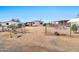 Mobile home behind a chain link fence on a dirt lot, with a clear blue sky at 1936 S Mariposa Rd, Apache Junction, AZ 85119