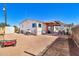 A property showcasing its exterior, featuring a spacious yard and covered patio with outdoor seating at 1936 S Mariposa Rd, Apache Junction, AZ 85119