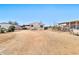 Exterior of mobile home featuring a dirt lot, covered parking, and clear blue sky at 1936 S Mariposa Rd, Apache Junction, AZ 85119