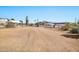 Exterior mobile home community in the desert with dirt roads, clear skies, and native landscaping at 1936 S Mariposa Rd, Apache Junction, AZ 85119