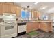 Traditional kitchen with white appliances, plants, and wood-look flooring at 1936 S Mariposa Rd, Apache Junction, AZ 85119